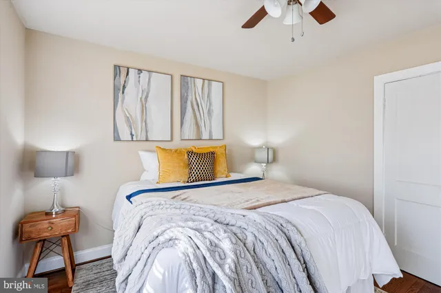 a bedroom with a bed and a lamp on table