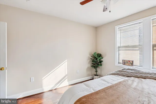 a bedroom with a bed and a potted plant