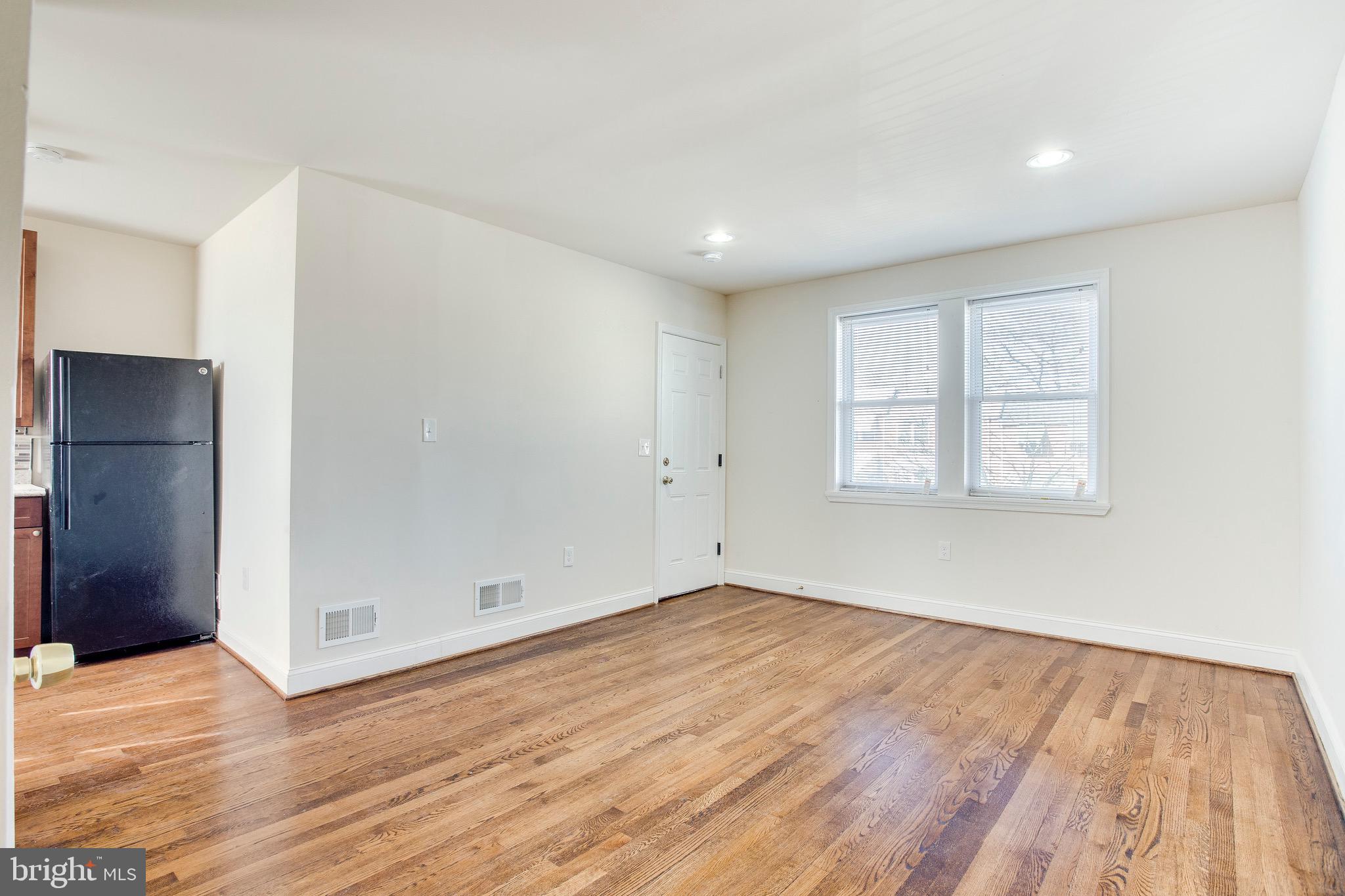 149 Denison Street, Unit 2 Baltimore, MD 21229 - Photo 5 of 19 a view of empty room with wooden floor and fan