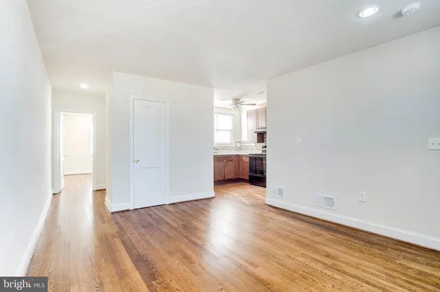 a view of a kitchen with wooden floor and a sink