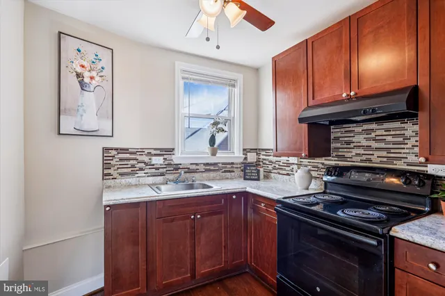 a kitchen with stainless steel appliances granite countertop a stove and a microwave