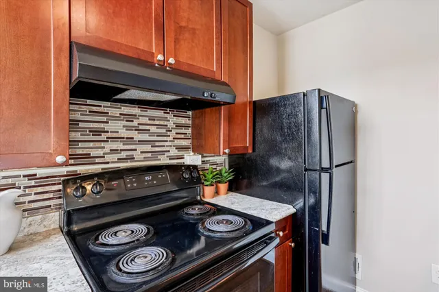 a kitchen with a stove and a refrigerator