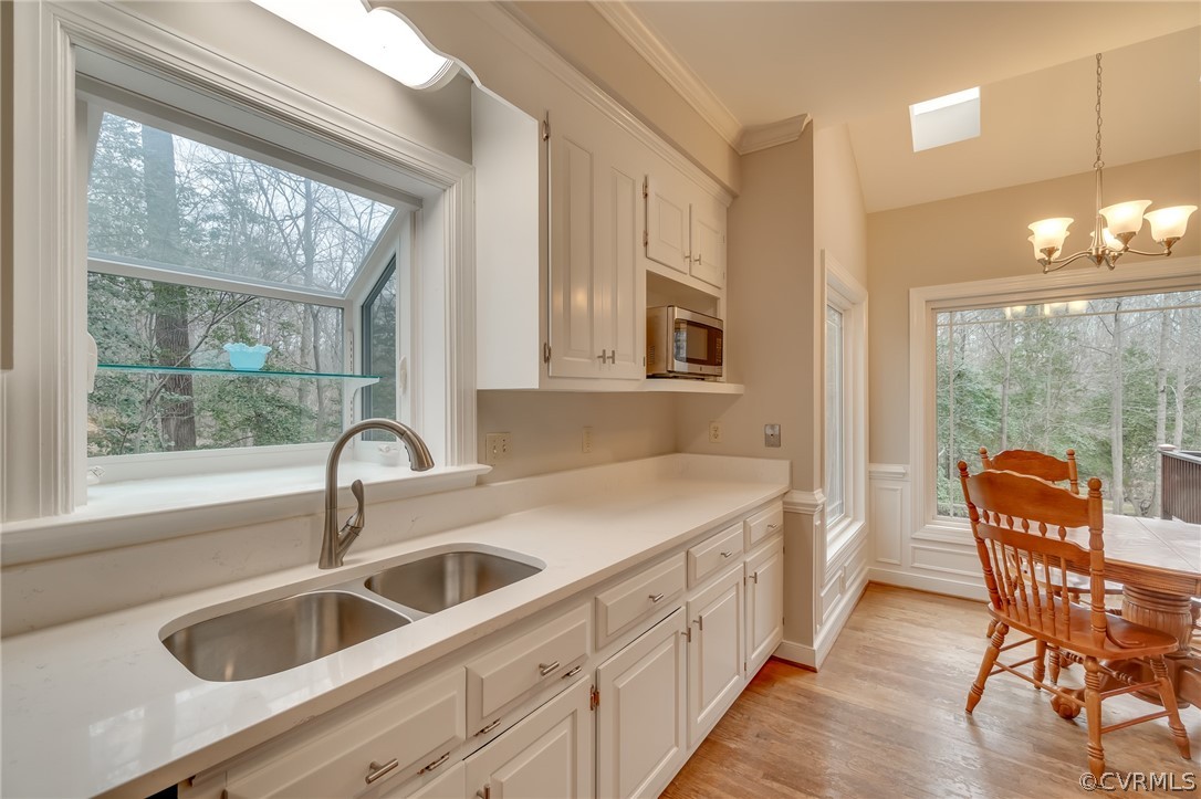 14621 Benefice Ridge Chesterfield, VA 23838 - Photo 22 of 49 a kitchen that has a sink a table and chairs in it