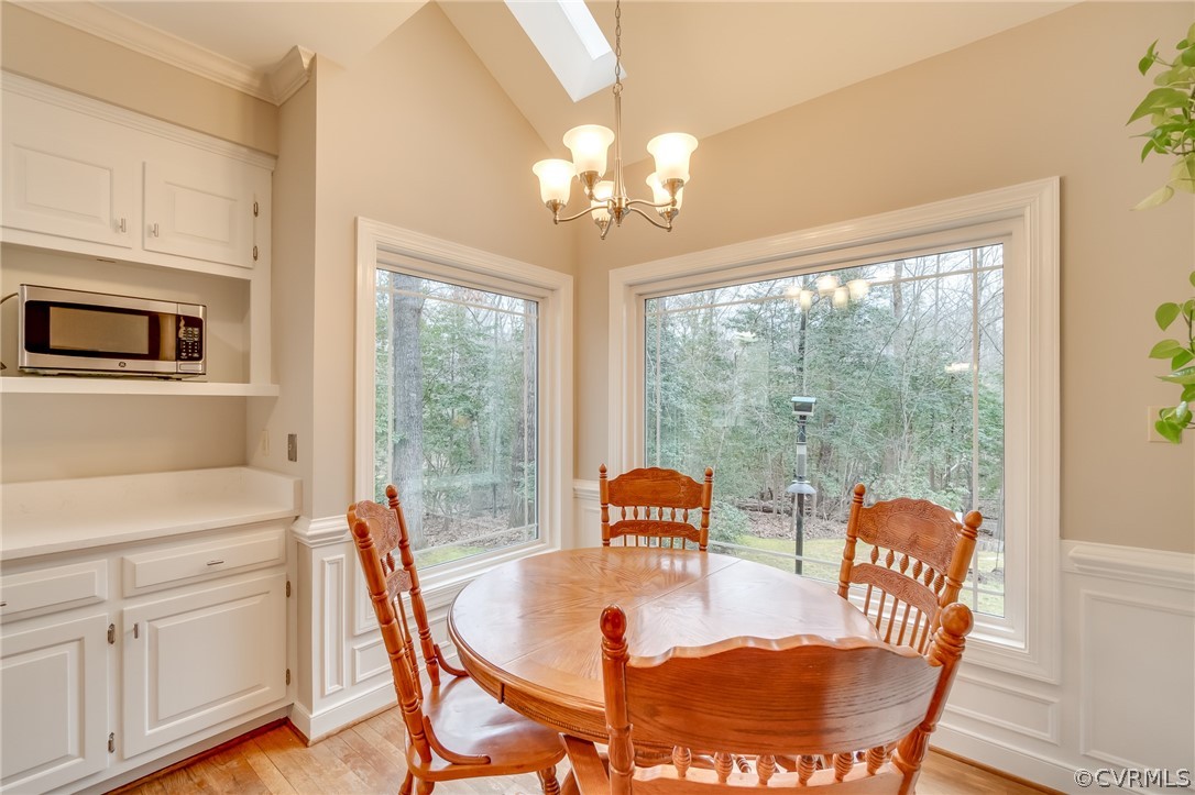 14621 Benefice Ridge Chesterfield, VA 23838 - Photo 24 of 49 a dining room with furniture a chandelier and wooden floor