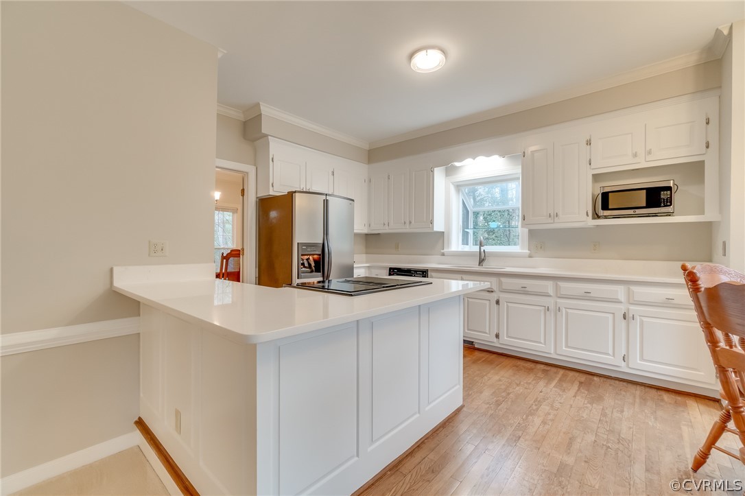 14621 Benefice Ridge Chesterfield, VA 23838 - Photo 26 of 49 a kitchen with white cabinets and stainless steel appliances