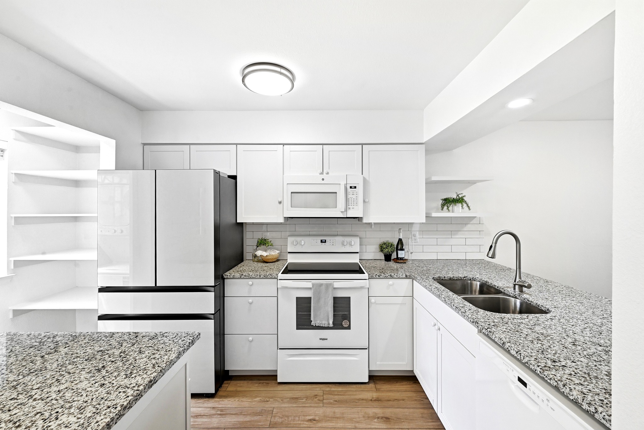 2215 Post Road, Unit 1026 Austin, TX 78704 - Photo 6 of 29 Stone counters, 2022 oven, microwave, dishwasher, 2025 refrigerator.