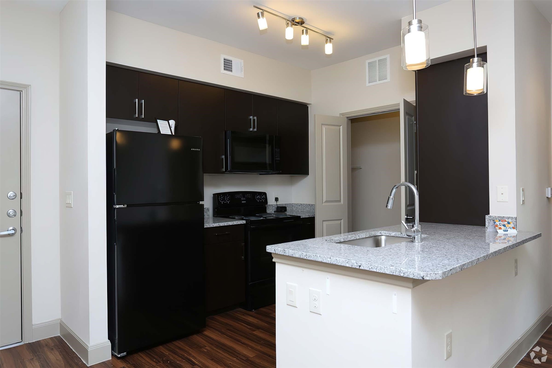 4604 Cypresswood Drive, Unit 2210 Spring, TX 77379 - Photo 17 of 29 a kitchen with a sink a refrigerator and cabinets