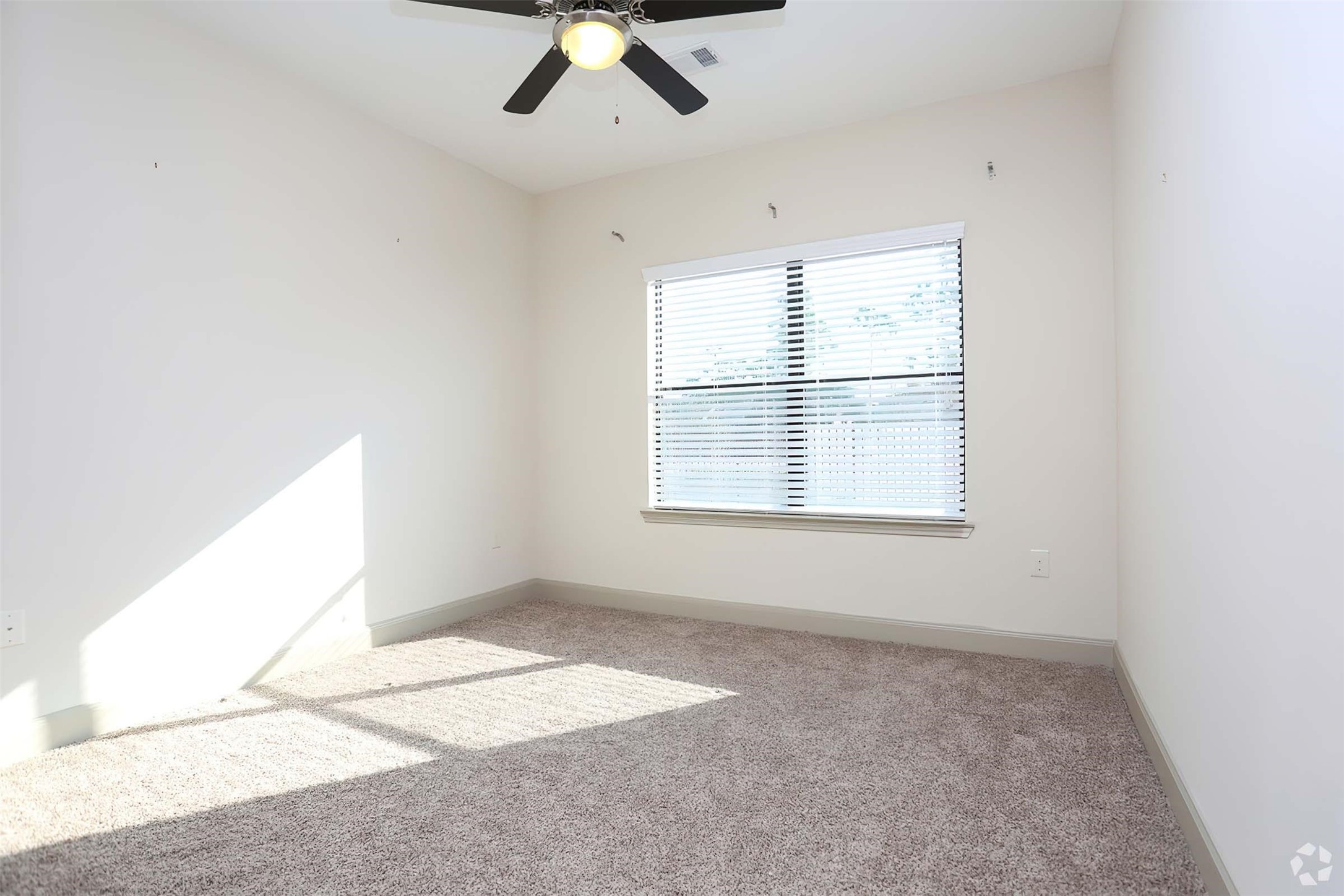4604 Cypresswood Drive, Unit 2210 Spring, TX 77379 - Photo 20 of 29 an empty room with a chandelier fan and windows