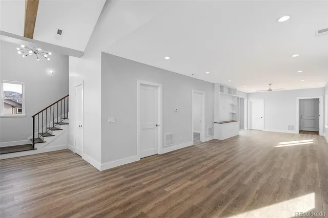 a view of an empty room with wooden floor