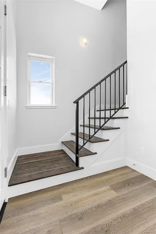a view of a hallway with wooden floor and a floor to ceiling window