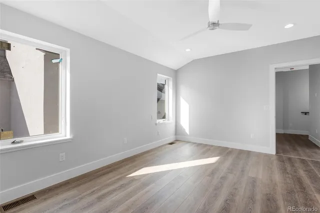 a view of an empty walk in closet with wooden floor