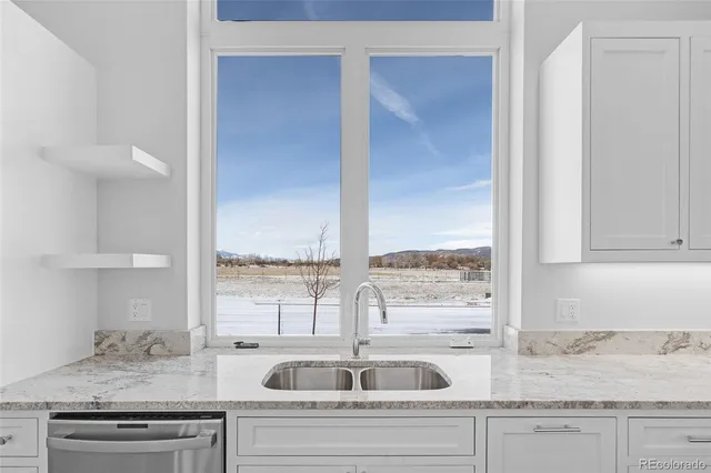 a kitchen with granite countertop a sink and a window
