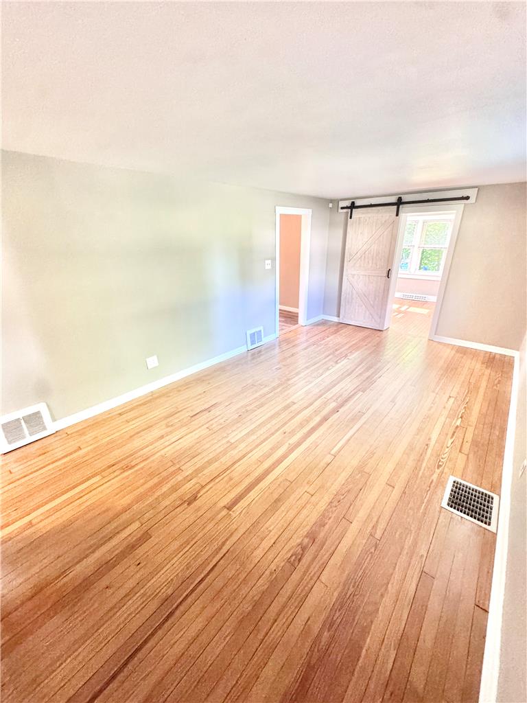 5454 Camp Meeting Road Center Valley, PA 18034 - Photo 3 of 27 Lustrous hardwood floors create an inviting atmosphere in this flexible living space.
