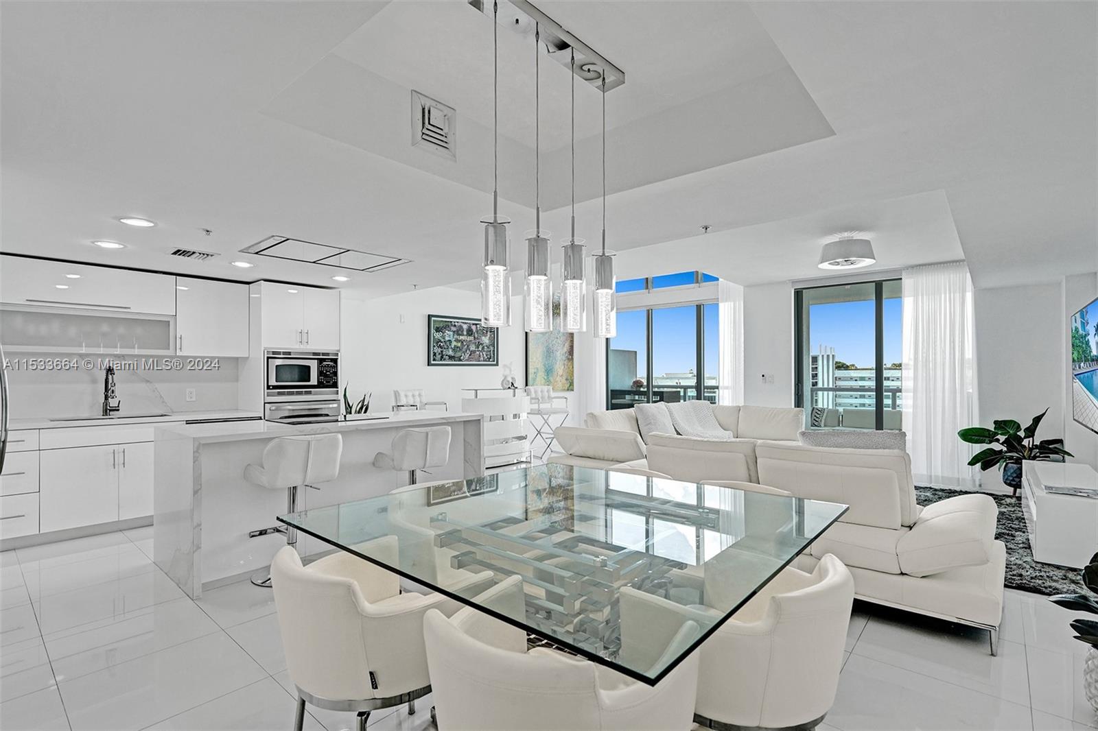 a living room with stainless steel appliances granite countertop furniture and a kitchen view