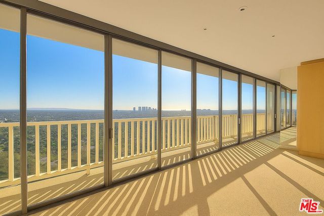 a front view of a house with garden and sitting area