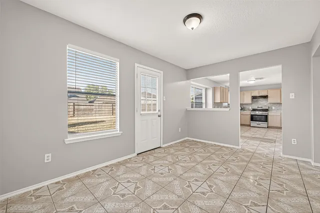 a kitchen with granite countertop a refrigerator sink and cabinets