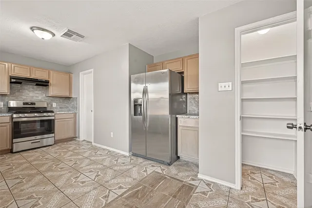 a kitchen with granite countertop a sink cabinets and window