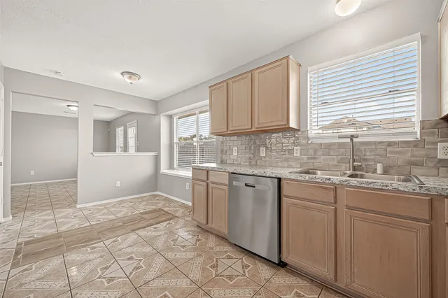 a kitchen with a stove a sink and a refrigerator