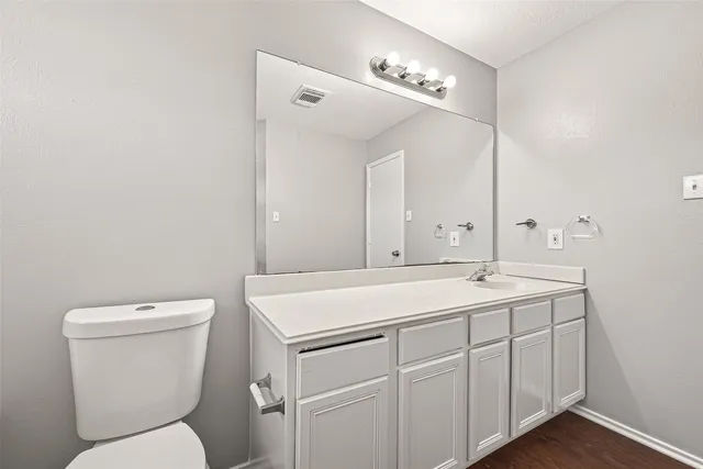 a white toilet sitting next to a bath tub