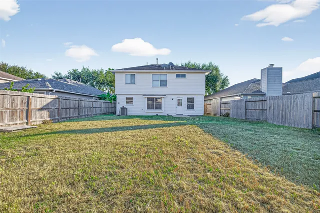 a view of a house with a backyard and a garden