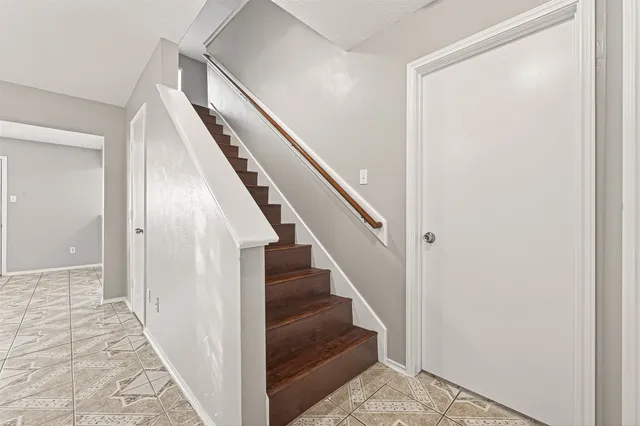 a view of a hallway with wooden floor and entryway