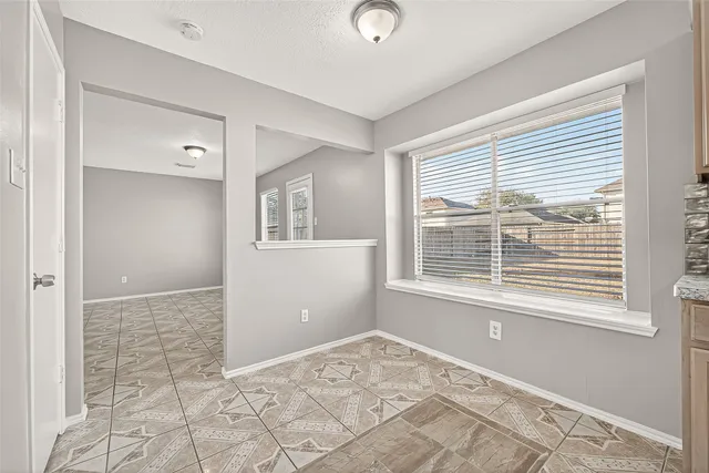 a view of an empty room with a window