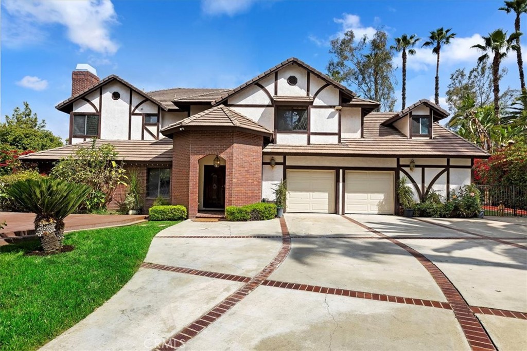 1515 Muirfield Road Riverside, CA 92506 - Photo 1 of 1 a view of a white house with a large windows and a yard with plants