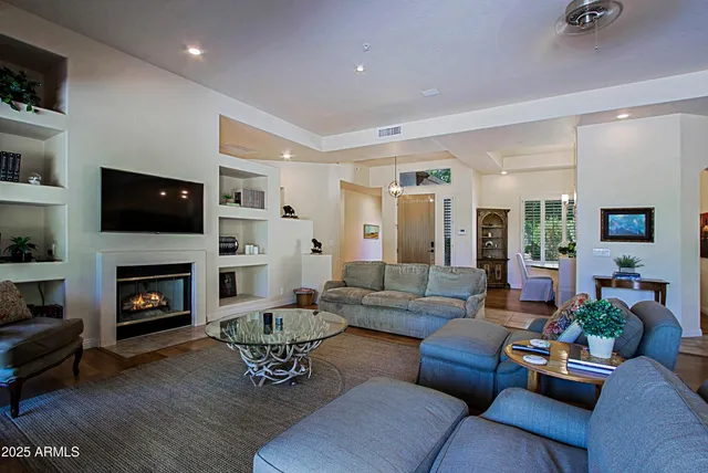 a living room with furniture and a floor to ceiling window
