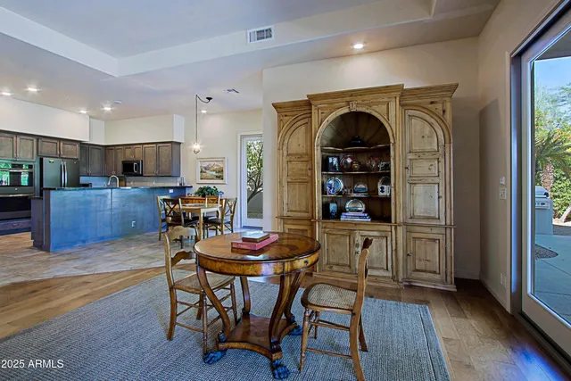 a view of a dining room with furniture wooden floor and chandelier