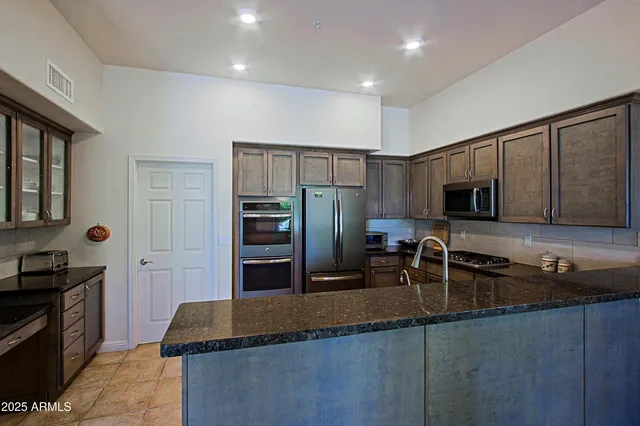 a dining room with furniture a chandelier and wooden floor