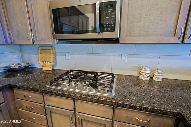 a bedroom with a bed and large windows