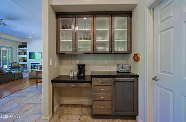 a spacious bedroom with a bed table and a lamp