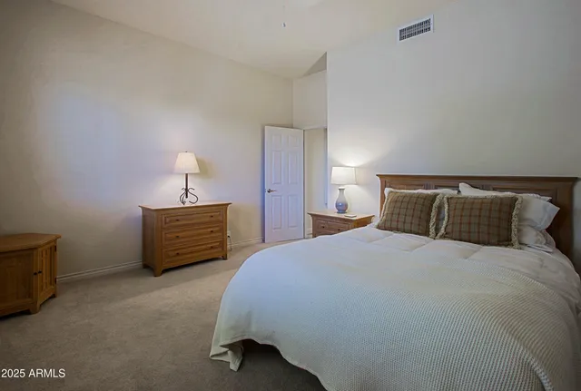 a living room with lots of furniture and a large window