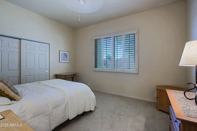 a living room with lots of furniture and floor to ceiling window