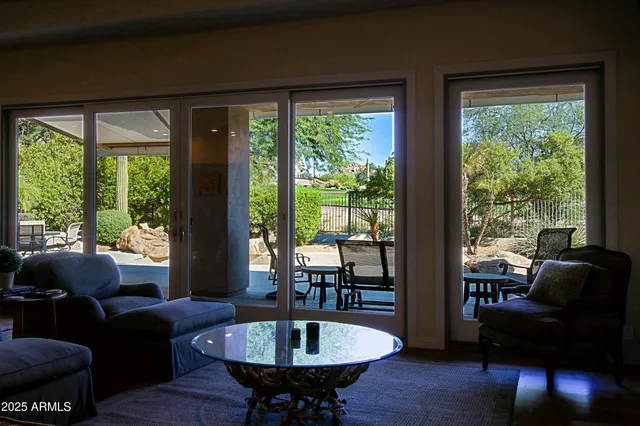 a living room with furniture and a dining table