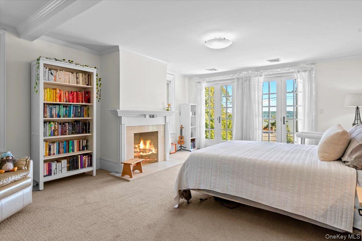 245 River Road Nyack, NY 10960 - Photo 33 of 45 Carpeted bedroom with ornamental molding and a fireplace with flush hearth