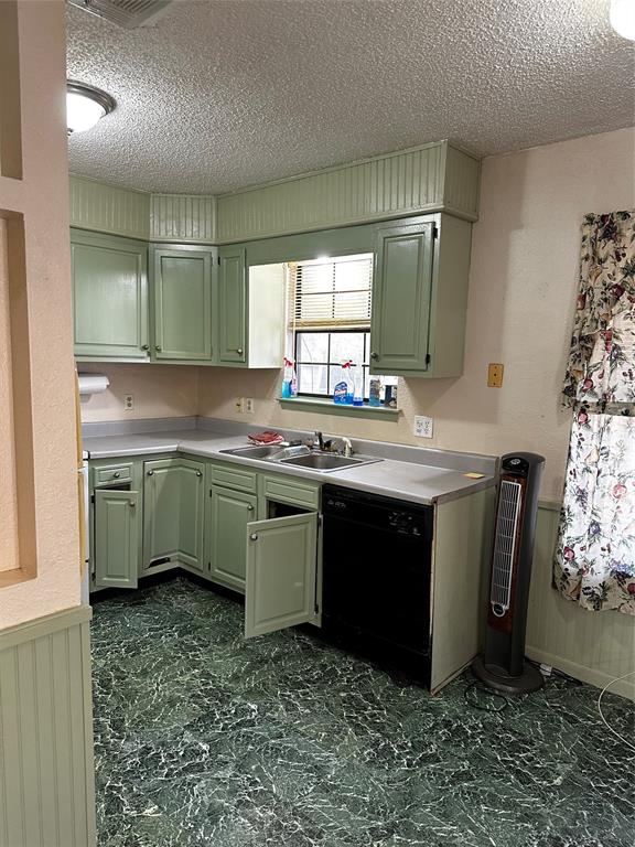 1430 Maple Avenue Paris, TX 75460 - Photo 3 of 11 a kitchen with a sink stove and cabinets