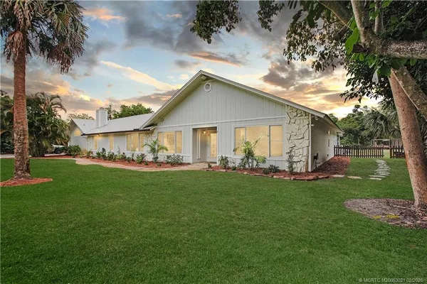 a view of a house with a yard and porch