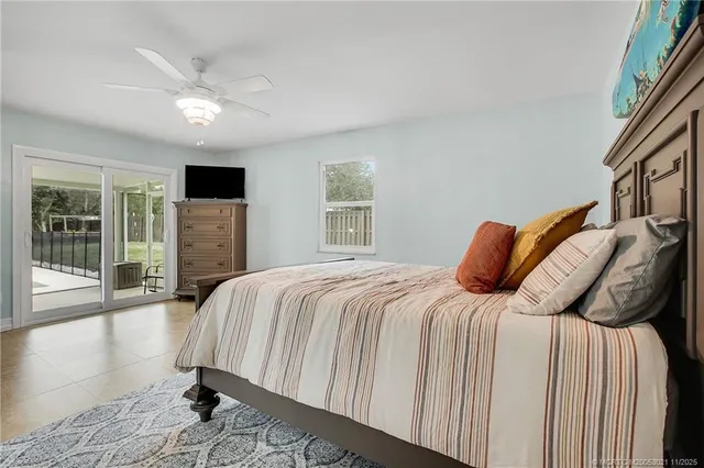 a bedroom with a bed and a large window