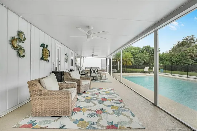 a living room with furniture and a floor to ceiling window