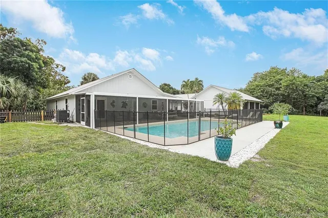 a view of a house with backyard and porch