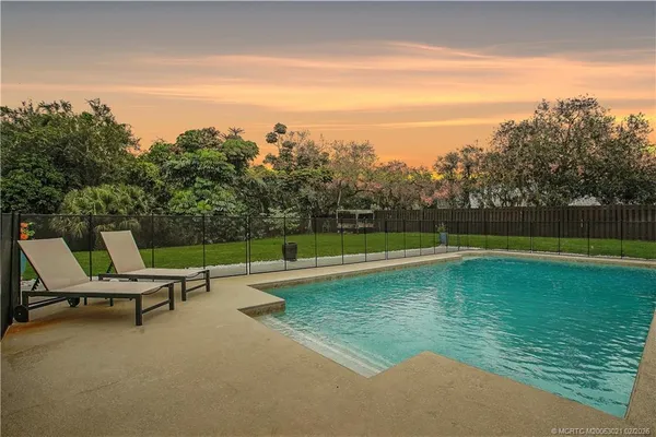 a view of a swimming pool with a yard