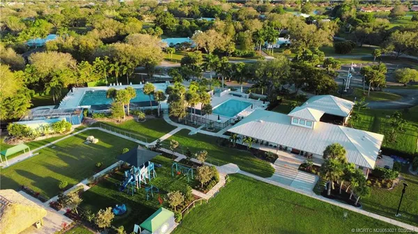 an aerial view of a house with yard swimming pool and outdoor seating