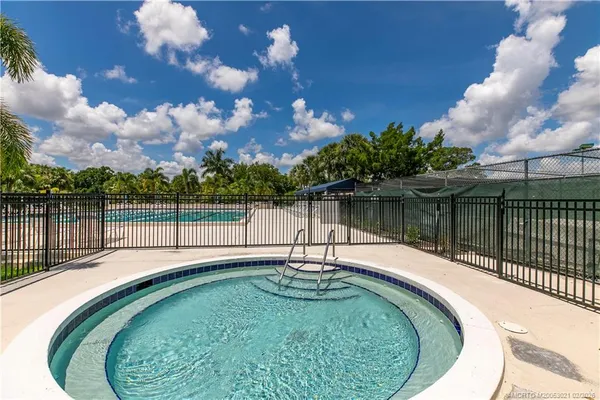 a swimming pool with outdoor seating and garden