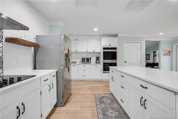 a large kitchen with cabinets appliances and a counter space