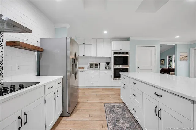 a large kitchen with cabinets appliances and a counter space