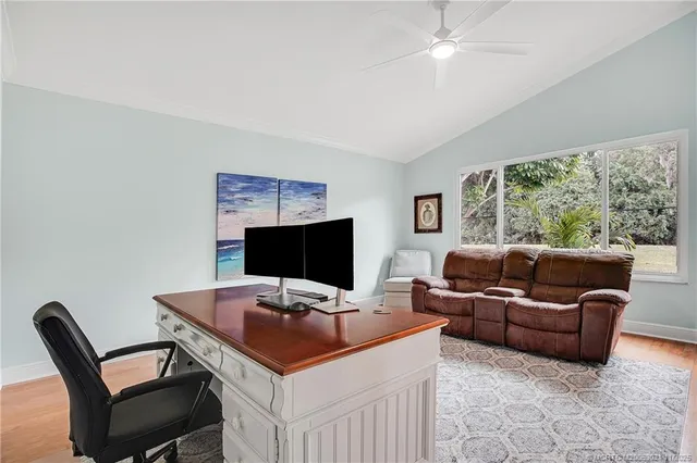 a view of a livingroom with workspace and a couch