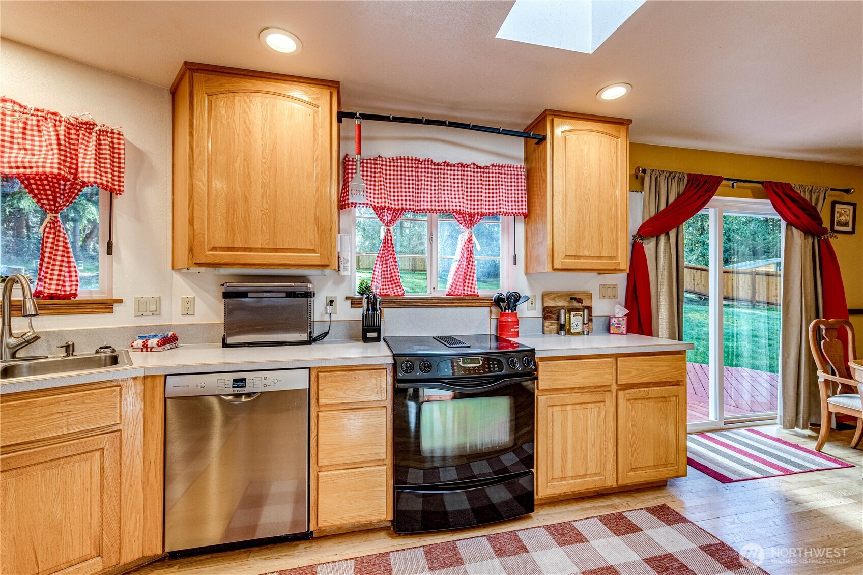 73 Ross Lane Port Angeles, WA 98363 - Photo 12 of 40 a kitchen with a stove a sink and a microwave