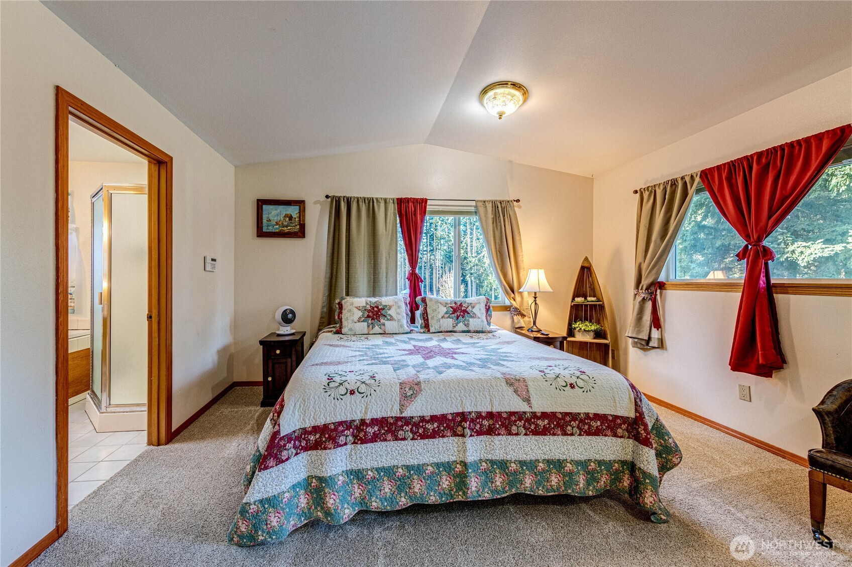 73 Ross Lane Port Angeles, WA 98363 - Photo 23 of 40 a bedroom with a bed a dresser and a large window