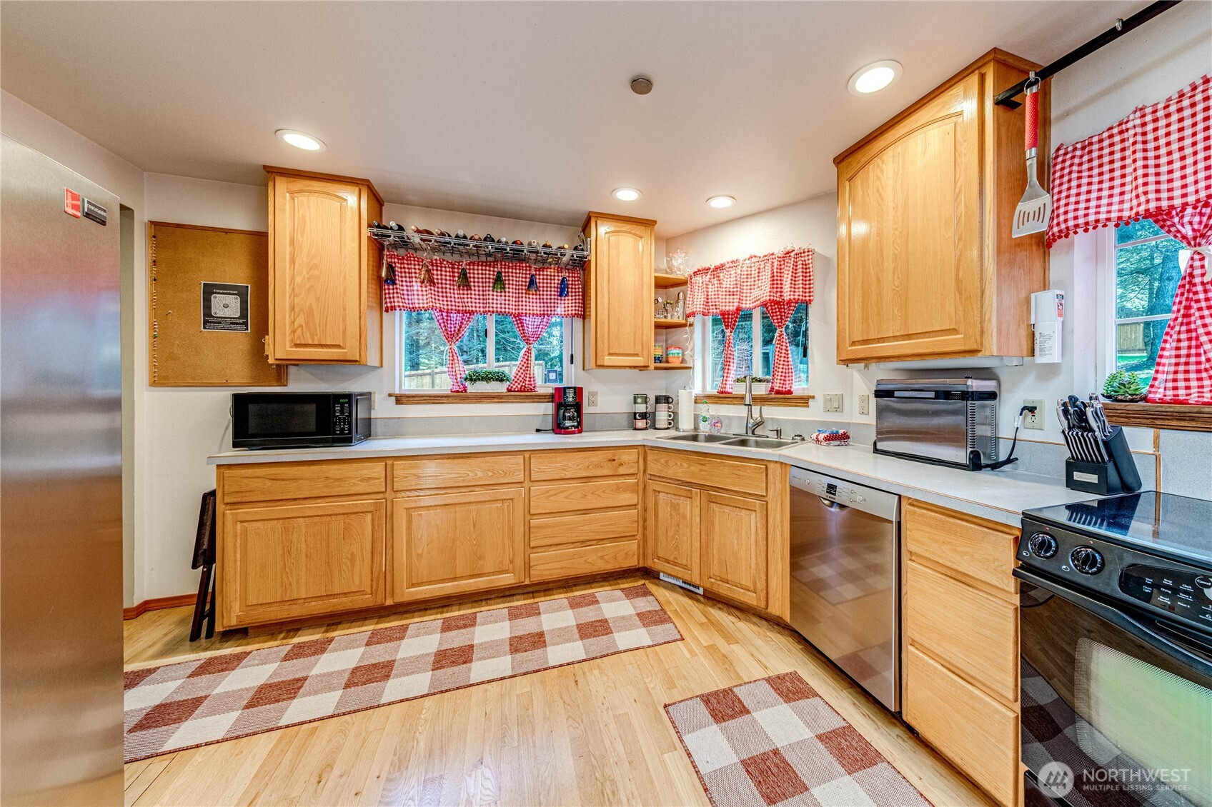 73 Ross Lane Port Angeles, WA 98363 - Photo 10 of 40 a kitchen with stainless steel appliances granite countertop a sink and wooden cabinets